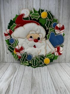 a close up of a santa clause on a wooden surface