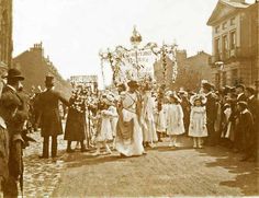 an old photo of people standing in front of a crowd