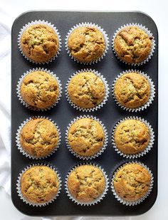 twelve muffins sitting on top of a black tray