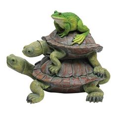 a statue of two turtles riding on top of a turtle that is sitting on it's back