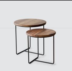 two tables with metal legs and wood tops, one on top of the other side