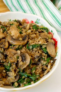 a white bowl filled with rice and mushrooms