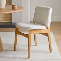 a wooden chair sitting on top of a white rug