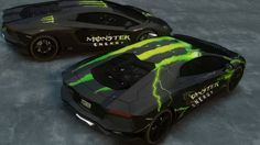 two black and green sports cars side by side on a gray surface with the words monster energy painted on them