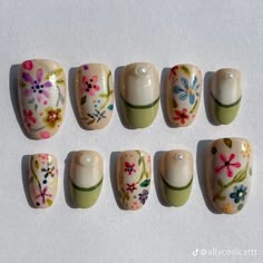 six different sized nails with flowers painted on them