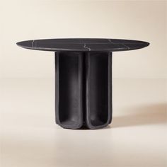 a round table with two black vases on the top and one in the middle