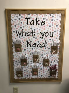 a bulletin board that says, take what you need with small pins attached to it