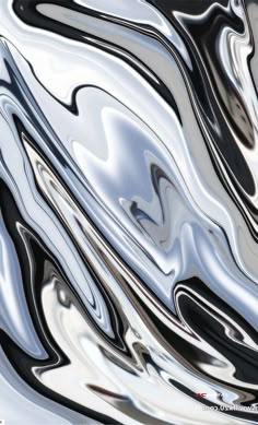 an abstract image of black and white paint on the surface, as well as silver foil