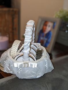 a white basket filled with lots of different types of shoes on top of a table