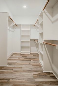 an empty walk in closet with white walls