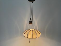 a light fixture hanging from the ceiling with two lights attached to it's sides