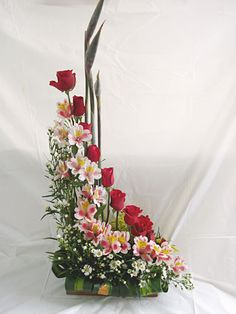 an arrangement of flowers arranged in a basket