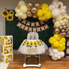 a birthday party with sunflowers and balloons