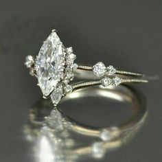 a close up of a diamond ring on a table