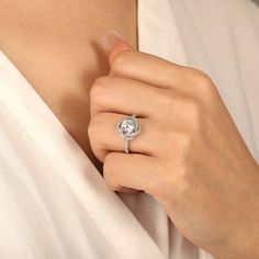 a woman wearing a diamond ring on her finger