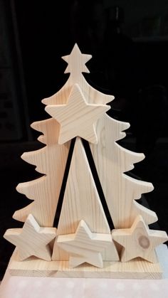 a wooden christmas tree with stars on it