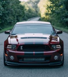 the front end of a red and black mustang