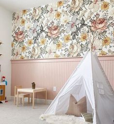 a child's playroom with a teepee tent in the corner and floral wallpaper on the walls