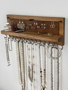 The Original All-in-One Wall-Mounted Jewelry Organizer - Handmade in the USA FEATURES: * Double row of staggered hooks - choice of Black, Silver or Gold * Cute and unique wires to hold dangle and hoop earrings * Cork panel holds stud earrings - backs stay on! * Easy to hang flush mount  * Woman-owned, minority-owned, and veteran-owned business Organize your necklaces, bracelets, and earrings with this beautiful, functional jewelry shelf! This handcrafted jewelry organizer adds a touch of charm t Wall Hanging Necklace Holder, Earrings Organizer Ideas, Unique Jewelry Organizer, Diy Wood Jewelry Holder, Diy Necklace Holder Easy, Jewlrey Organization Wall Diy, Necklace Wall Display, Jewerly Organizer Ideas, Wall Jewelry Holder