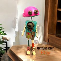 a toy robot sitting on top of a wooden table