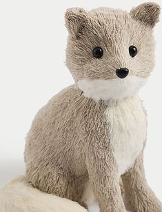 a stuffed animal sitting on top of a white surface