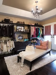 a bedroom with a bed, closet and chandelier hanging from it's ceiling