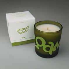 a green candle sitting next to a box