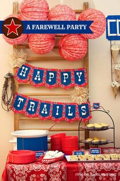 a table topped with red, white and blue desserts next to a sign that says happy trails