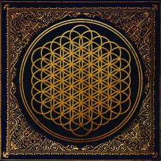 the flower of life is shown in gold on black paper, with an ornate border around it