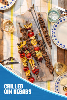 a wooden cutting board topped with meat and veggies on top of a table