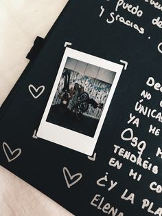 a black board with writing on it and a photo in the middle that has been drawn onto