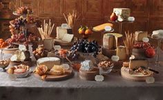 a table topped with lots of different types of cheese