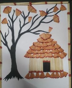 an art project made out of paper with a tree and birdhouse in the background