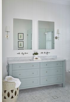 a bathroom with two sinks and mirrors in it