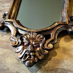 an ornate mirror on a wooden table