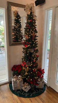 a decorated christmas tree with presents under it