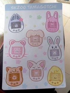 a person holding up a sticker sheet with some animals on it