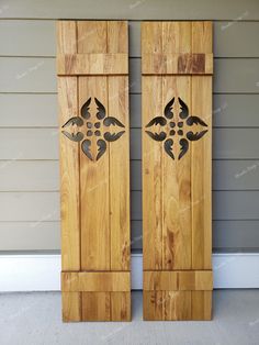 two wooden doors with decorative designs on them