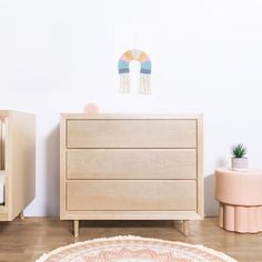 a baby's room with two cribs, a dresser and a bed