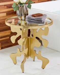 a glass table with flowers and towels on it