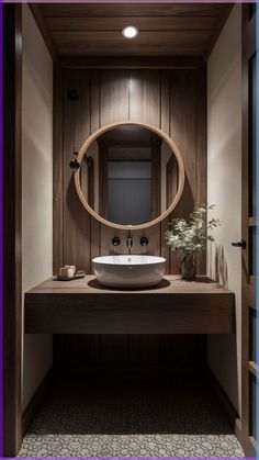 a bathroom with a sink, mirror and wood paneling on the wall behind it