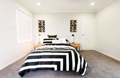 a black and white striped bed in a bedroom