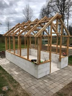 a house being built in the middle of a yard with brick pavers and grass