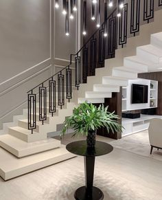 a living room filled with furniture and a stair case