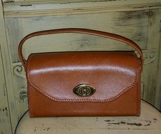 THIS IS A BEAUTIFUL VINTAGE 50'S ERA LEATHER HANDBAG ,BROWN WITH BROWN WHIP STITCHING,BRASS TURN LATCH CLOSURE.CLOTH  LINED.MEASURES 6" TALL X 10" LONG AND 4" DEEP.NO MARKINGS,NO LEATHER WEAR,A VERY COOL UNIQUE HANDBAG.SMOKE FREE HOME.SEE MORE GREAT VINTAGE BAGS IN MY STORE! SHIPPING IN US 12.65 CANADA 25.00 OVERSEAS PRIORITY INSURED 65.00 Vintage Crossbody Satchel For Formal Occasions, Vintage Formal Crossbody Satchel, Retro Vintage Brown Crossbody Satchel, Vintage Crossbody Satchel With Detachable Handle, Vintage Brown Retro Satchel For Daily Use, Retro Vintage Brown Satchel For Daily Use, Vintage Evening Crossbody Satchel, Mid-century Brown Satchel Bag, Retro Vintage Brown Top Handle Shoulder Bag