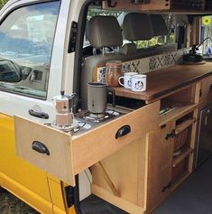 the interior of a van with coffee mugs on it