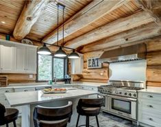 a large kitchen with an island in the middle and lots of stools around it