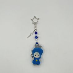 a keychain with a cartoon character on it and a star hanging from the back