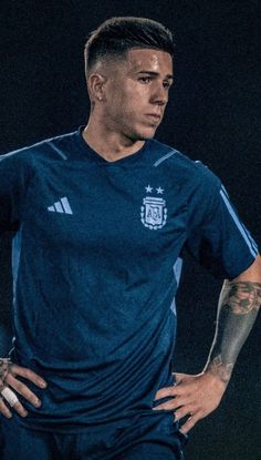 a soccer player with tattoos on his arms