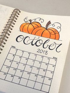 a calendar with an orange pumpkin and the word october written in black ink on it